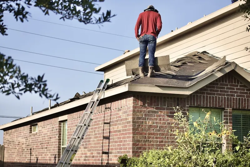 Professional roofer working on a residential roof in Golfside